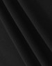 A close-up of black cotton fabric, displaying its soft texture and stretch. Includes a branding logo.