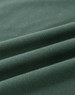 A close-up of a folded green cotton fabric, showcasing its soft texture and stretchability.