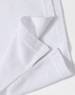 A close-up of a white polo shirt featuring a folded hem and a subtle logo.