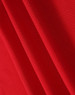 A red fabric with a textured surface, showcasing the material of a polo shirt. It has a logo in the corner.