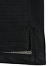A black polo shirt featuring a textured fabric and side slit detail, also has a logo on it.