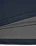 A close-up of a navy blue men's polo shirt featuring a textured fabric with a contrasting inner layer.