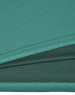 A close-up view of a teal bamboo charcoal polo shirt, showcasing its textured fabric. The shirt features a logo.