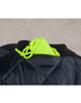 A hi-vis two-tone flying jacket in black and bright yellow, featuring a quilted design and a hood tucked into the collar.