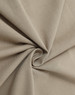 A close-up of soft, beige cotton fabric, showcasing its smooth texture and drape.