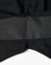 A close-up of black rip-stop poly/cotton stretch work shorts featuring a waistband detail. The shorts have a logo.