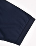 A navy blue men's sustainable poly/cotton polo shirt showcasing the cuff detail with a logo.