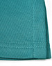 A close-up of a teal sustainable poly/cotton polo shirt showing the fabric texture and stitching details.