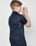 A navy blue kids' polo shirt featuring short sleeves and contrast detailing. The shirt includes a logo.