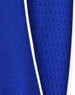 A close-up of a blue polo shirt featuring contrasting fabric textures and a white trim. It has a logo on the garment.
