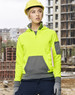 A bright yellow and grey two-tone hoodie featuring a front pocket and a logo, worn by a person in a construction setting.