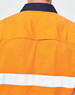 A safety shirt in orange with a navy collar and reflective white tape on the back. It features a logo.