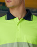A bright yellow and navy blue segmented polo shirt with a collar and a pocket. It has a logo.