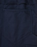 A close-up of navy pants featuring a segmented design and a rear pocket. The fabric has a ripstop texture.