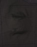 A close-up view of unisex black cotton stretch drill cuffed work pants, featuring pockets and a sturdy design.