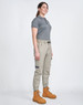 Unisex cotton stretch drill cuffed work pants in khaki, paired with a grey polo and tan work boots. Features pockets and an elastic waistband.