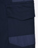A close-up of navy blue unisex cotton stretch drill work pants featuring a side pocket and patch detail.
