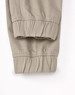 A pair of unisex cotton stretch drill cuffed work pants in khaki, featuring elastic cuffs and a simple design.