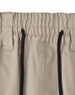 A pair of beige unisex cotton stretch drill work shorts featuring an elastic waistband and black drawstring.