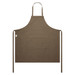 A brown canvas apron featuring a front pocket and neck ties. The apron has a branding label. A brown canvas apron featuring a front pocket and neck ties. The apron has a branding label.