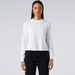 A white long sleeve tee, featuring a round neckline and a fitted design, worn with dark jeans.