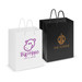 A medium laminated carry bag in white with purple logo and a black bag with gold logo, featuring sturdy handles. A medium laminated carry bag in white with purple logo and a black bag with gold logo, featuring sturdy handles.