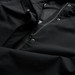 A soft shell jacket in black, featuring a zip and snap closures, with a textured interior lining. A soft shell jacket in black, featuring a zip and snap closures, with a textured interior lining.