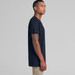 A navy blue T-shirt on a model, featuring a simple design and a logo on the front. A navy blue T-shirt on a model, featuring a simple design and a logo on the front.