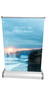 A silver table top pull-up banner featuring a scenic coastal sunrise image, with dimensions outlined. A silver table top pull-up banner featuring a scenic coastal sunrise image, with dimensions outlined.