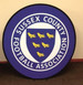 A round pop-up banner featuring a blue background with a shield and yellow birds, including a logo.
