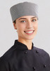 A chef cap in a black and white checkered pattern, worn by a smiling individual in a black chef's uniform. A chef cap in a black and white checkered pattern, worn by a smiling individual in a black chef's uniform.