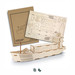 A wooden model of a cargo ship in a natural finish, alongside its assembly instructions, featuring a branding logo.