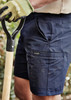 Mens lightweight outdoor shorts in navy blue, featuring a side pocket and a logo, paired with a gardening tool. Mens lightweight outdoor shorts in navy blue, featuring a side pocket and a logo, paired with a gardening tool.