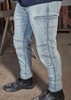 A pair of light blue stretch jeans with cargo-style pockets, worn with black work boots. A pair of light blue stretch jeans with cargo-style pockets, worn with black work boots.