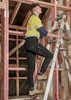 Men's lightweight outdoor cargo pants in black worn by a person on a ladder, set in a construction environment.