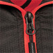 A close-up of a zip on a black thermal jacket featuring red accents and a logo.