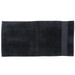 A dark black beach towel featuring a simple design, ideal for leisure and outdoor use. It has a logo on one side. A dark black beach towel featuring a simple design, ideal for leisure and outdoor use. It has a logo on one side.