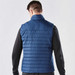 A navy blue quilted vest with a high collar, viewed from the back, featuring a subtle logo detail. A navy blue quilted vest with a high collar, viewed from the back, featuring a subtle logo detail.