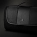 A black picnic blanket with a textured surface and a logo on the top, featuring a foldable design and carrying handle.
