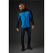 A men's softshell jacket in blue and black, featuring a zippered pocket and a logo. Styled with dark jeans and shoes.