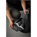 A black duffle bag being opened, revealing a pair of shoes inside. The bag has a logo on it. A black duffle bag being opened, revealing a pair of shoes inside. The bag has a logo on it.