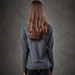 A long-sleeved grey women's tee viewed from the back, featuring a simple design and a logo.