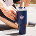 A drink bottle in navy blue with a straw and a logo. The design features an easy-grip handle. A drink bottle in navy blue with a straw and a logo. The design features an easy-grip handle.