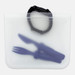 A transparent PEVA reusable food storage bag with a black strap, containing purple utensils inside.