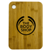 A large bamboo cutting board with rounded corners, featuring a logo on the surface. A large bamboo cutting board with rounded corners, featuring a logo on the surface.