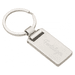 A silver keychain with a rectangular charm and a metal ring, featuring a logo on the surface.