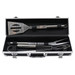 A stainless steel BBQ set with spatula, fork, and tongs in a sleek black deluxe case.