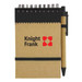 A brown recycled jotter pad with a black pen and elastic band, featuring a logo on the cover.