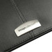 A black leather zippered compendium featuring a silver branding plate. A black leather zippered compendium featuring a silver branding plate.