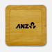 A bamboo coaster featuring a square shape and a black logo. The surface is smooth and polished. A bamboo coaster featuring a square shape and a black logo. The surface is smooth and polished.